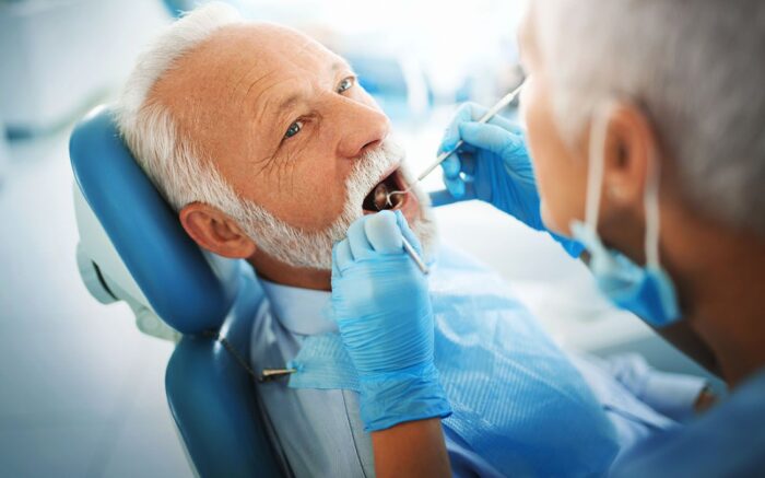 man having his teeth checked by dental professional teeth cleaning dentist Oxnard California
