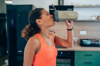 woman drinking protein shake or smoothie after a home workout oral and body health preventative dentistry dentist in Oxnard California
